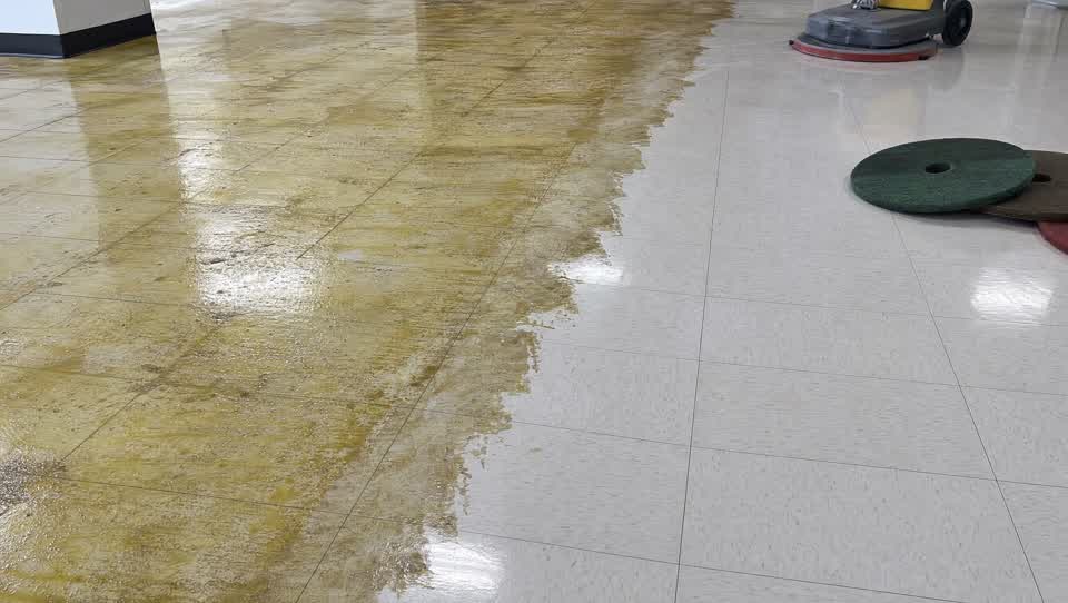 Commercial floor mid-strip, old finish being removed to reveal clean tile